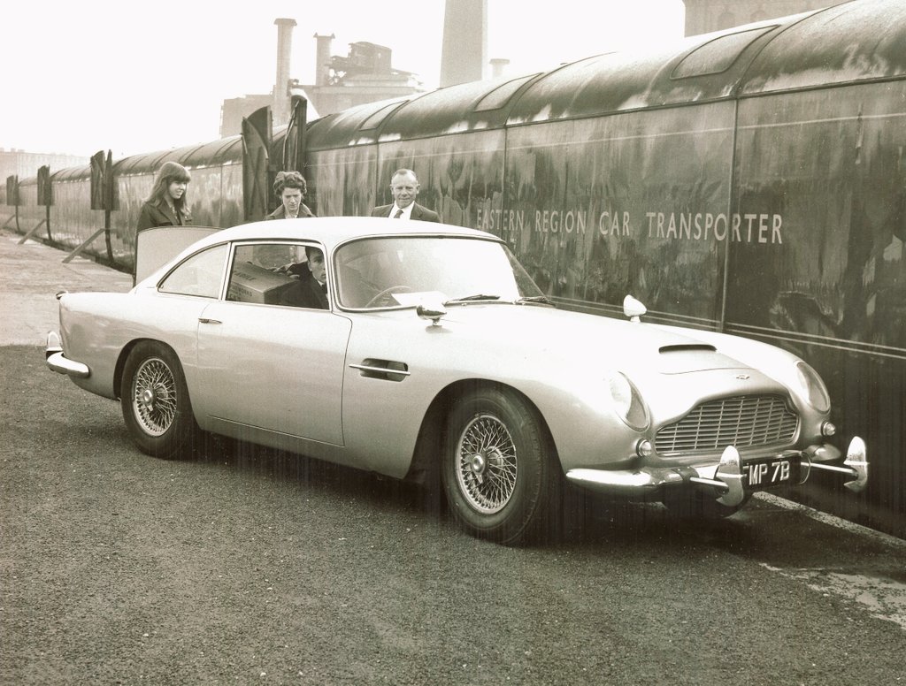 The names Rail, #BritishRail 🚂🍸.... #JamesBond 007 #AstonMartinDB5 #FMP7B (#Goldfinger 1964) being loaded onto the Daytime #AngloScottishCarCarrier at the #CaledonianRoad loading bay, #BR Publicity Dept. to promote ASCC 07/65.... #Motorail @RailwayCentral