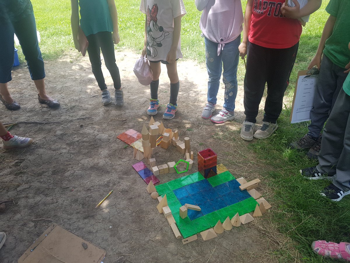 Grade 1s were building homes today using 3D figures. They were given a list of figures to include and asked to identify 2D shaped they saw within the figures. Creativity meets teamwork and Geometry in this outdoor building challenge.