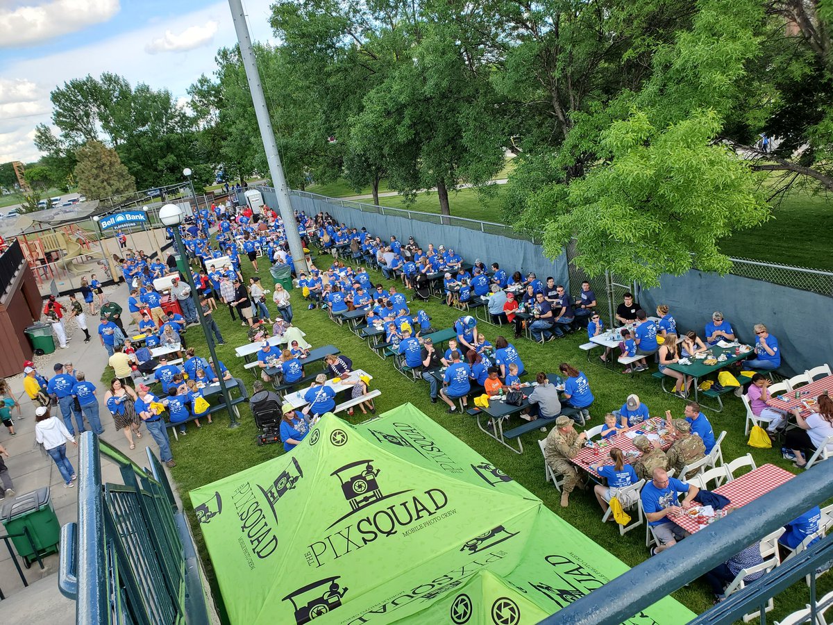 FMWFChamber's tweet photo. A sea of blue shirts and inflatable games means one thing... it's Military Appreciation Night picnic time! #fmwfmilitary https://t.co/8FeatNI568