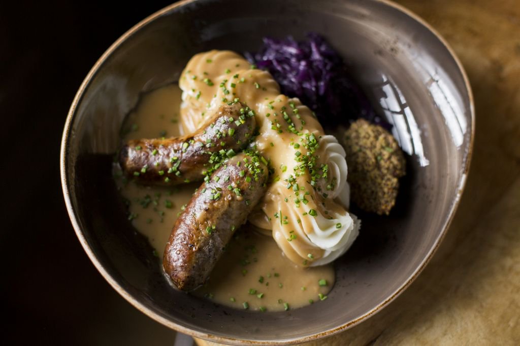 Bangers and mash is a classic dish from Great Britain! Our version is made with housemade sausage, mashed potatoes, gravy, braised red cabbage and pub mustard.