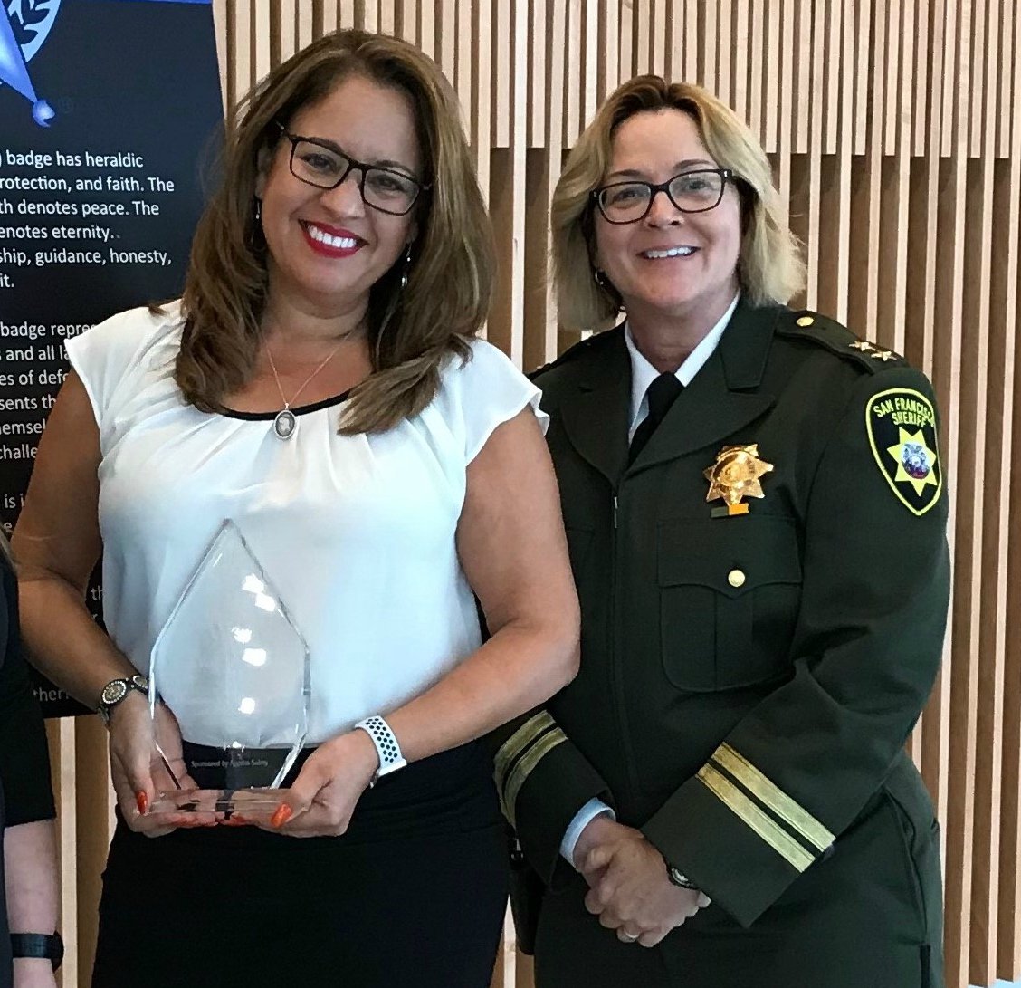 SheriffSF's tweet photo. Delia Ginorio, left, & @SheriffSF Capt. Michele Fisher accept the Crime Victim Services Award from @NationalSheriff this week, recognizing SFSD for Survivor Restoration Program. Last year, @SheriffSF worked w/ 114 new clients & 906 existing survivors, guiding them to recovery. https://t.co/Z6l9UGjsZM