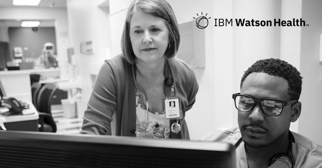 woman with stethescope and man looking at a computer in a hospital setting