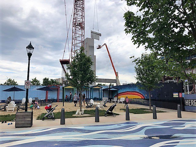 Watch as we build! Residents enjoy The Beach at Pike and Rose development in North Bethesda while Shockey Precast erects the complex's new seven-level precast parking garage in the background.