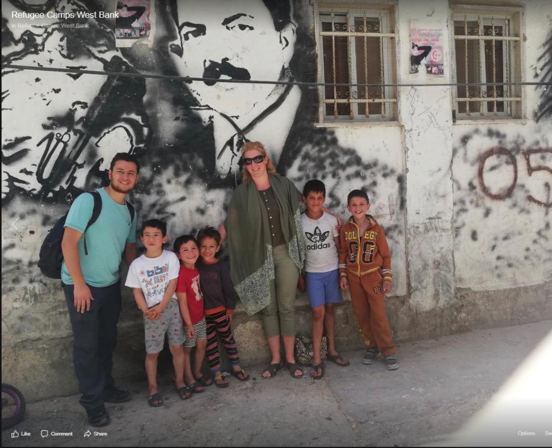 Irish_Chutzpah's tweet photo. Twitter didn't like this and locked the account because I didn't voluntarily remove the tweet.  Truth obviously hurts.  Claire Liddle  is clearly posing under a terrorist mural. I asked  in the thread for an explanation and an apology. @tomer_ilan @Ostrov_A https://t.co/ZpITvOjcC9