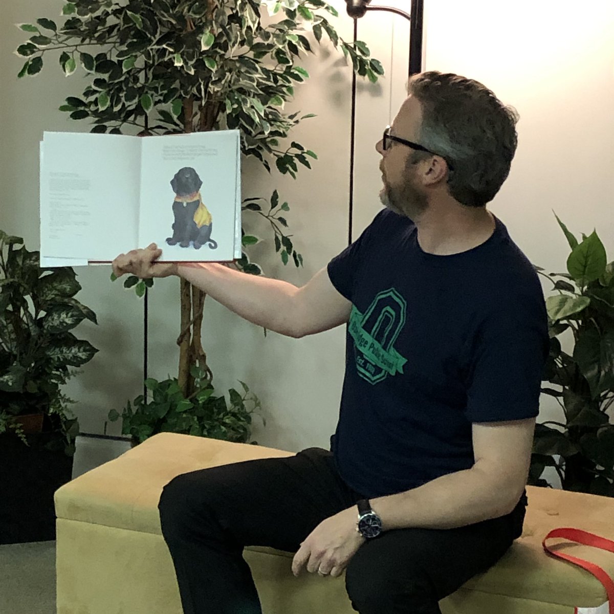 Mr. Gibson reading Caitie Copley and sharing stories about his own dog <a href="/the_storygarden/">The Story Garden</a>