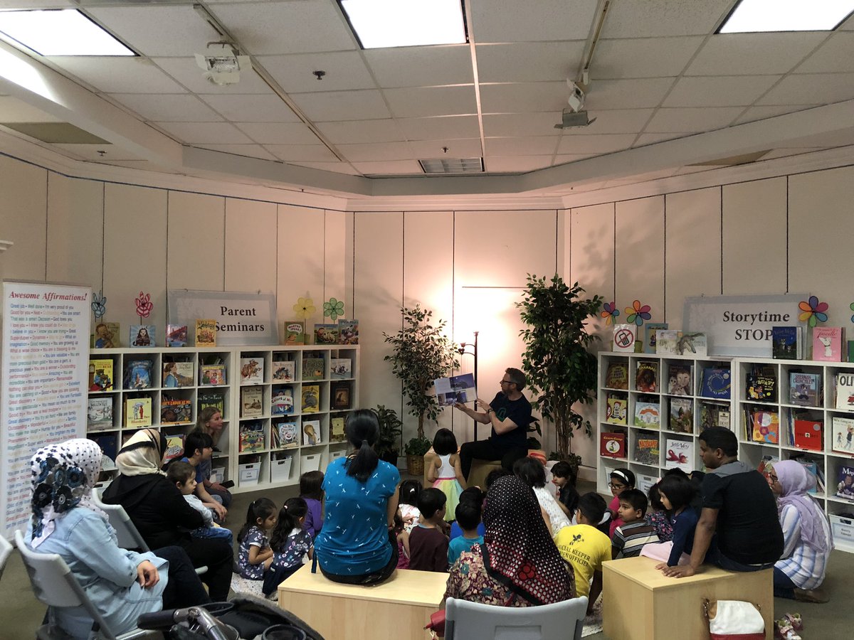 Oakridge PS families enjoying story time with Mr. Gibson <a href="/the_storygarden/">The Story Garden</a>