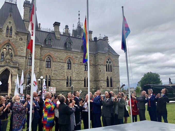 R_Boissonnault's tweet photo. Today, parliamentary colleagues &amp; I raised the #Pride and #Trans flags on Parliament Hill. Since 2016 we have ushered in Pride Season by raising our flags. We celebrate accomplishments and commit to the work ahead. Thank you to all who share our commitment to #LGBTQ2 Canadians. https://t.co/hnf0b8xQDW