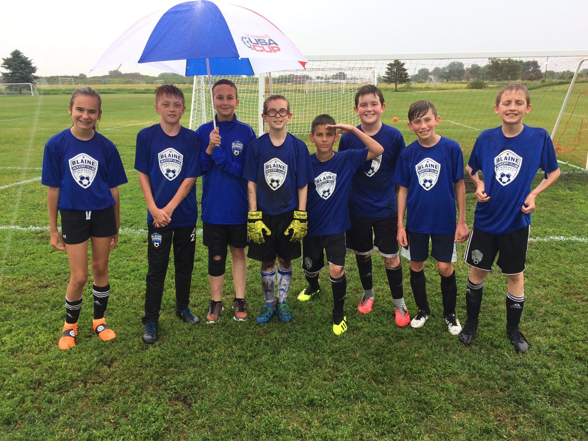 Coach_Bob14's tweet photo. No sun, no problem for the 07 Travel lads and Hayden. Everyone had fun in the rain and they were not afraid to get muddy. Also Jacob (umbrella) who is injured still came to be my assistant. This group of legends are an absolute joy to coach #joy #P1soccer @BlaineSoccerMN https://t.co/EDZ06L3DFI