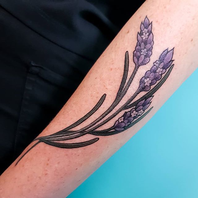 Illustrative lavender flower tattoo on the ankle.