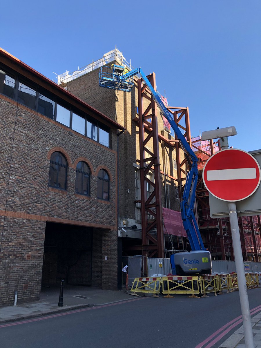 Sticking retro targets on a facade in Luton for monitoring. What would we do without a cherry picker? #monitoring #surveying #retros