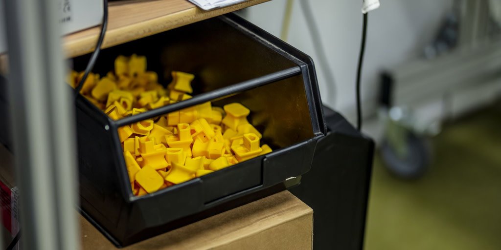 Ultimaker's tweet photo. #HowToMakeAnUltimaker - This yellow safety plug is 3D printed. It has 2 functions – it keeps the power switch in the off position, and keeps the electrical socket occupied to indicate the 3D printer has not yet been tested. #Ultimaker #InnovateEveryDay https://t.co/A5S1V3VORH