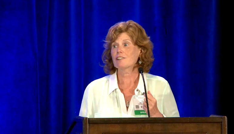 Kim Warchol speaking at AOTA's conference.