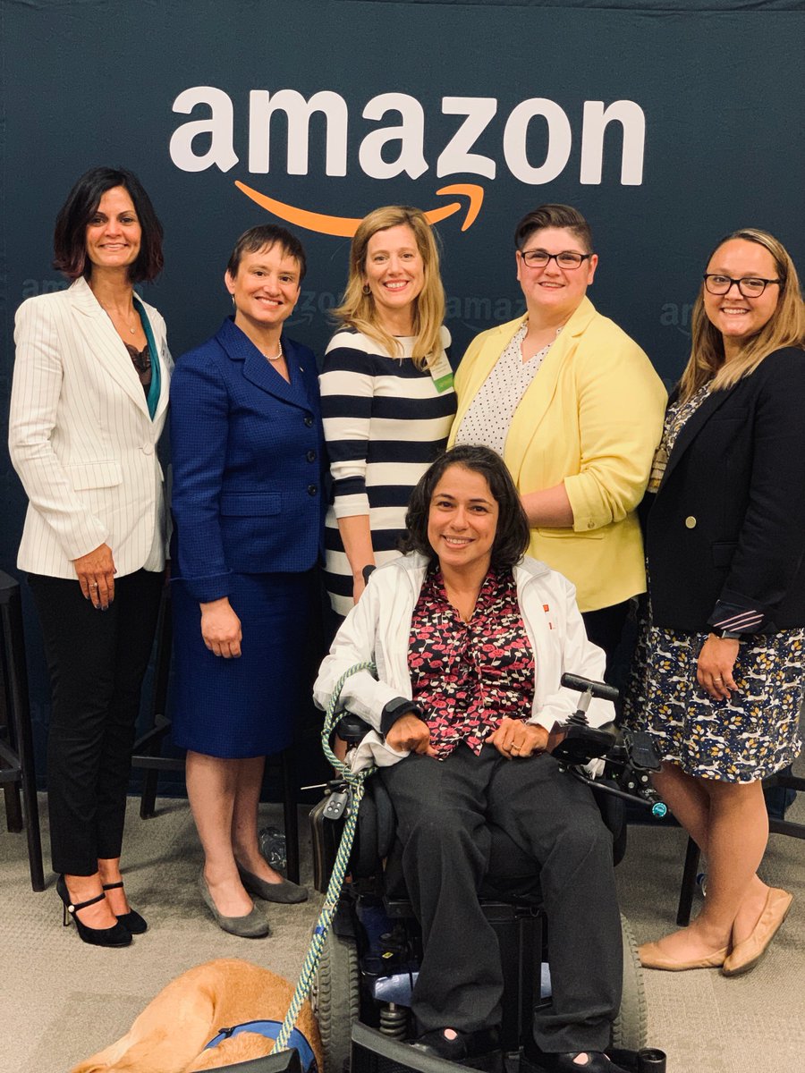 6 women in front of a navy blue wall with Amazon logo