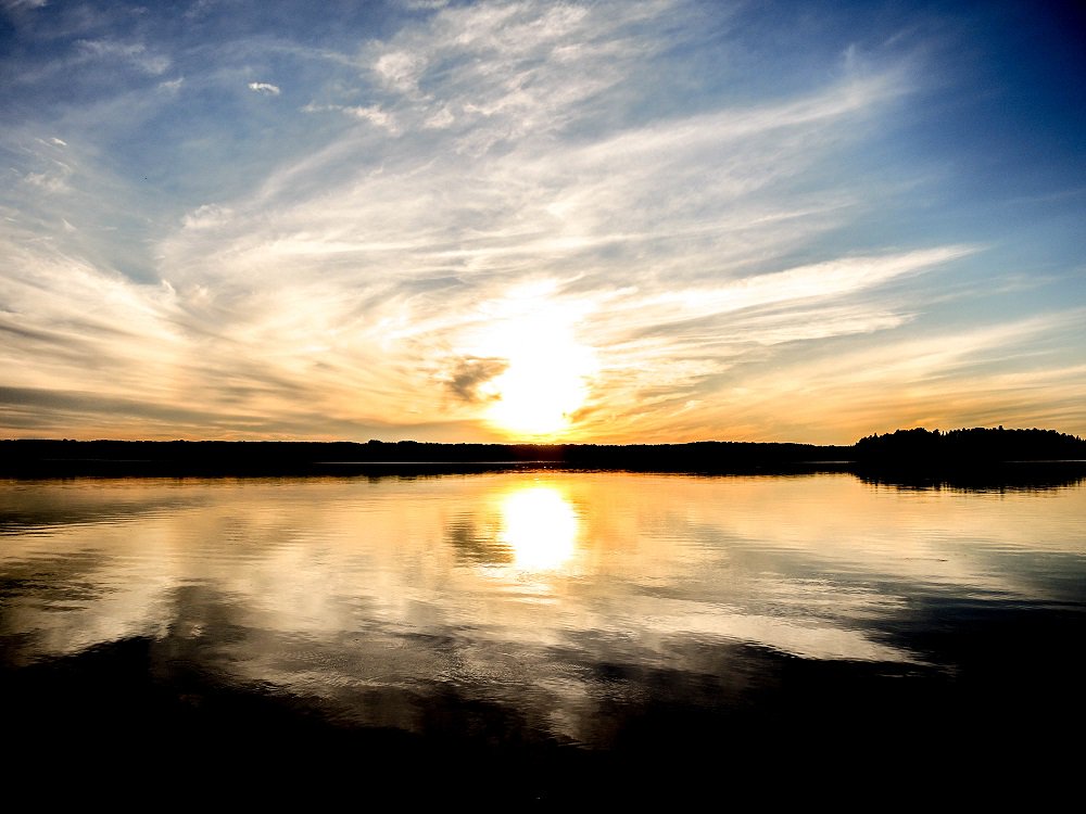 sun setting over water