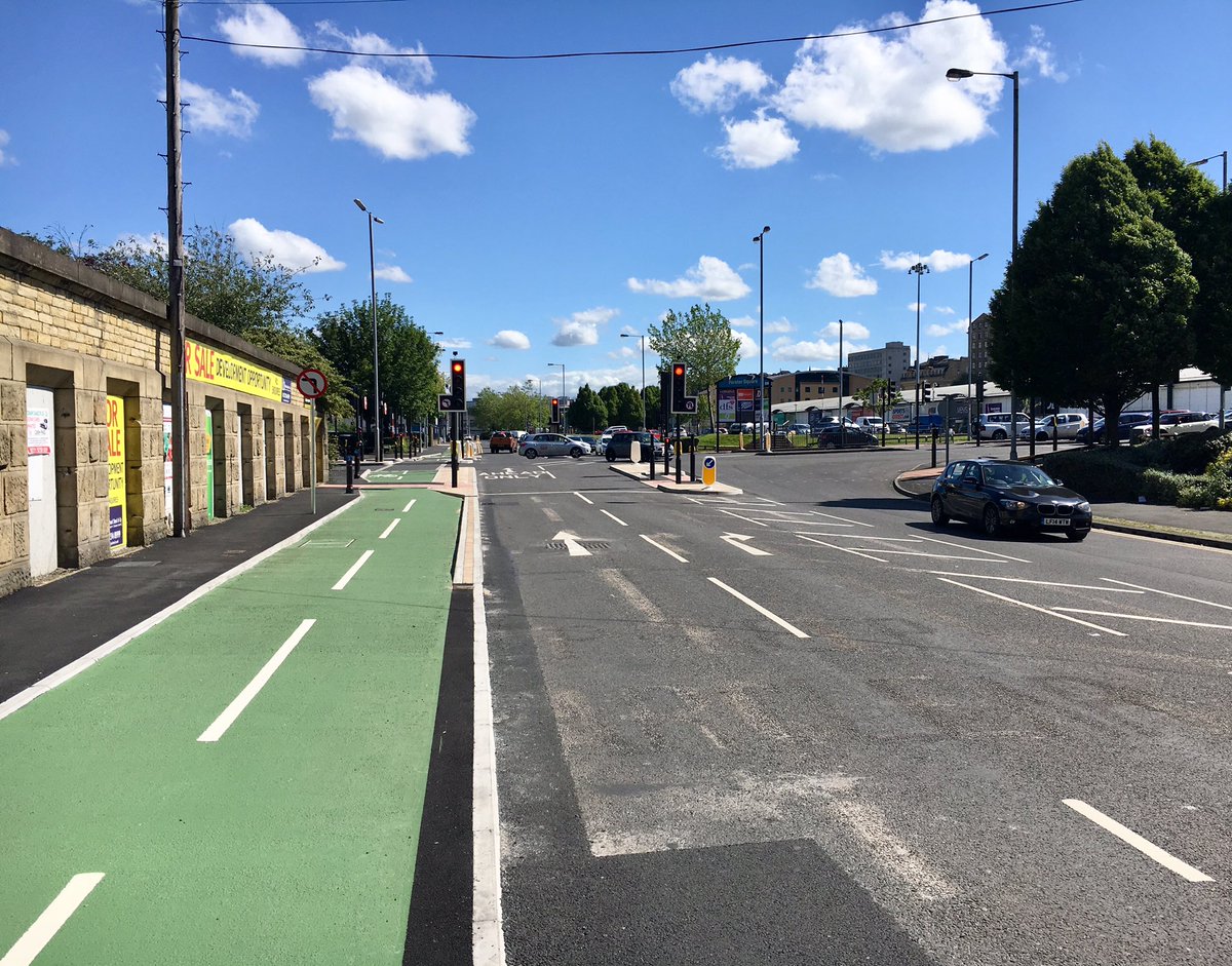 allymogg's tweet photo. Valley Road in Bradford, before and after a £3m cycle lane project now finished. Some local businesses weren’t happy about disruption, but the end result is great. They even improved the weather too: https://t.co/x7ZJO8G3DK #Cycleforcities (cc @guardiancities @helenpidd) https://t.co/BrcdTCF31f