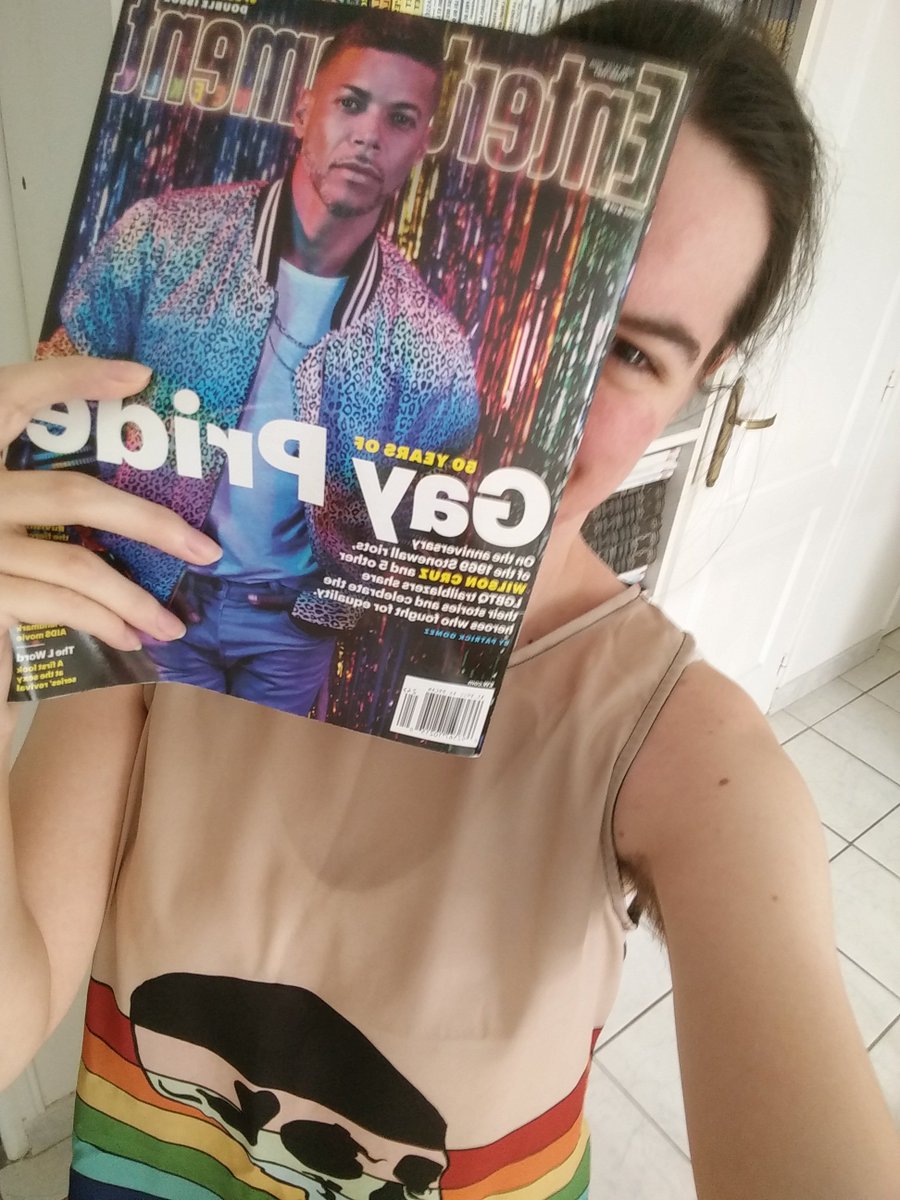 myself holding my copy of Wilson Cruz' EW cover, in front of my face, peeking from the side.