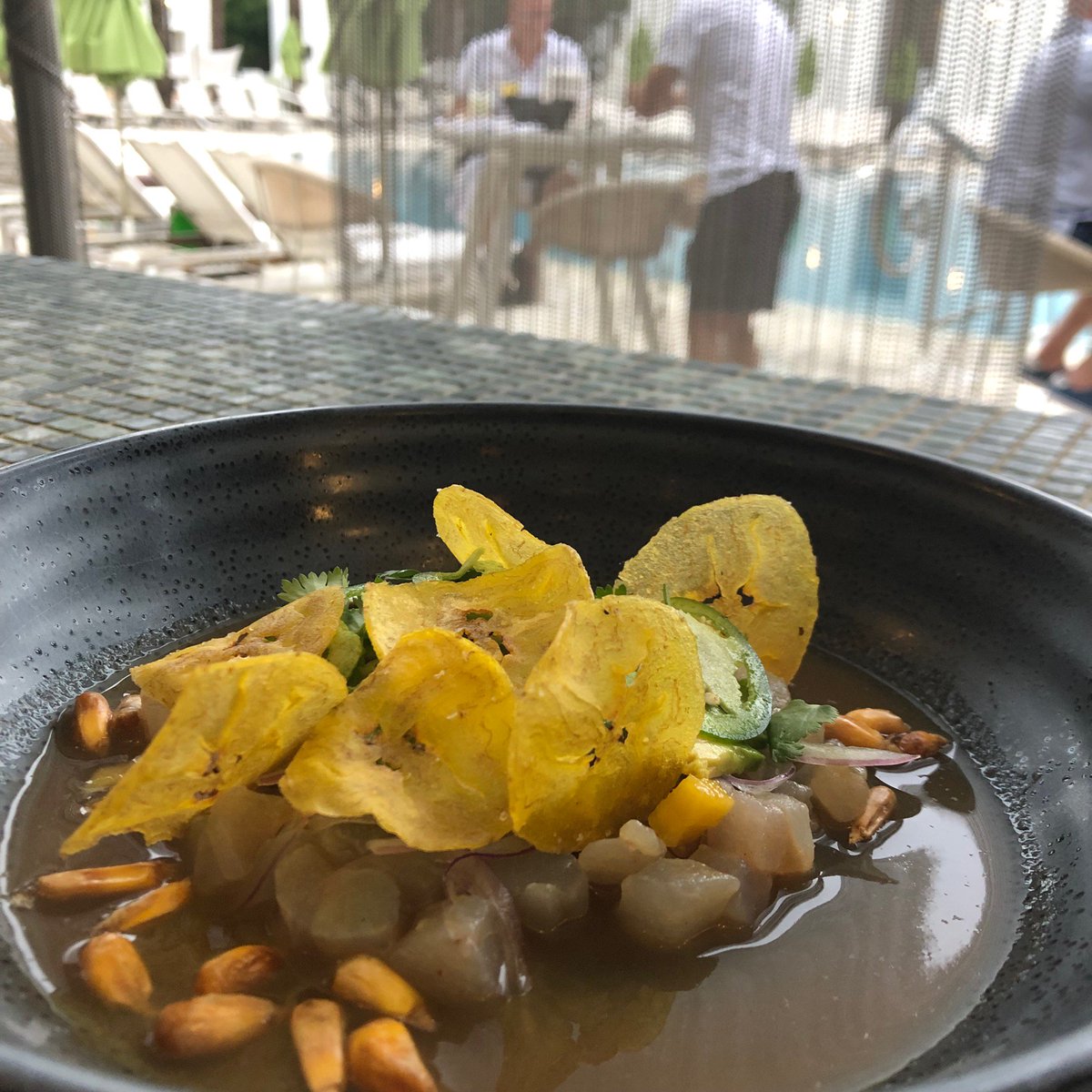 The Black Grouper Crudo is deliciously served with Tamarind Leche de Tigre, Avocado, Mango, Cilantro, Chulpe Corn, and Chilies. #dinealysbeach #calizarestaurant