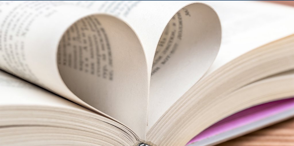 pages in a book folded into the spine to resemble a heart