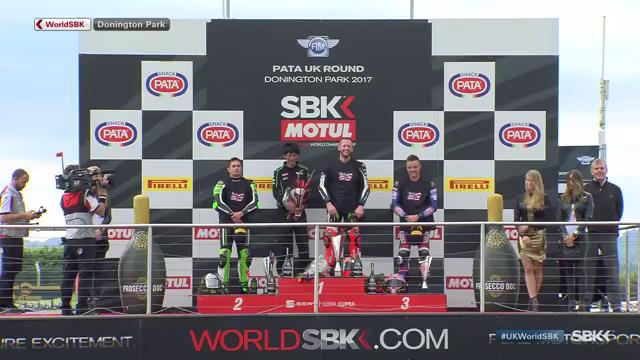 WorldSBK's tweet photo. Riders wearing #69 t-shirts on the podium in tribute to Nicky Hayden #RideOnKentuckyKid https://t.co/aiML9aMym8