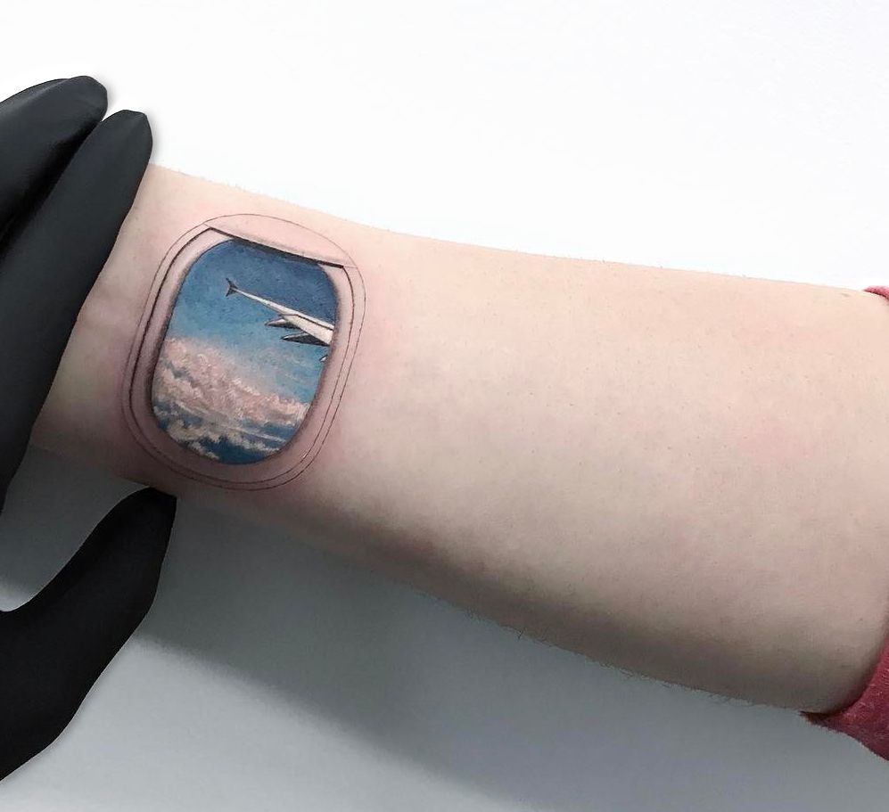 Airplane window tattoo on the inner ankle