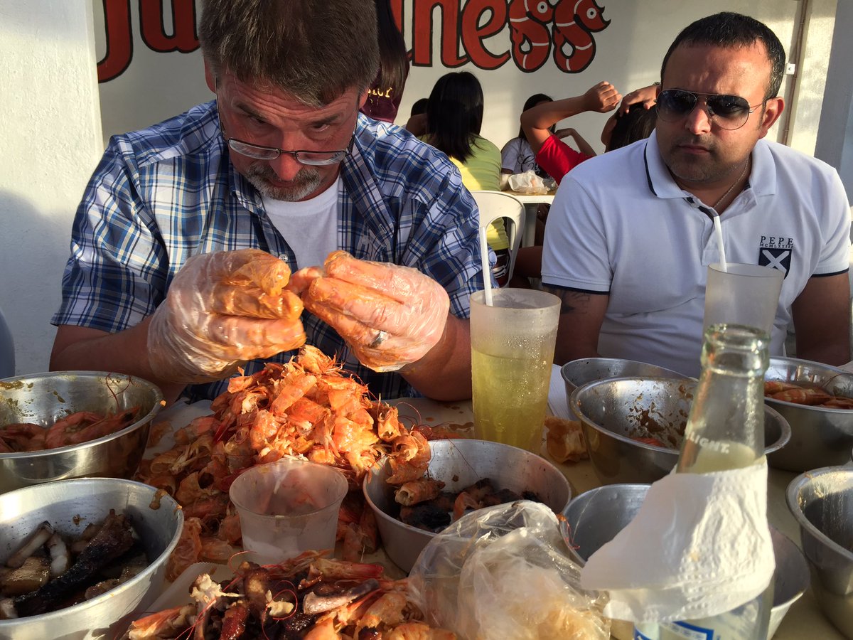 EricYamashiro's tweet photo. Such concentration...the shrimp did not stand a chance with Doug!! Look at his pile of shrimp shells!! https://t.co/Cztgr85t6C