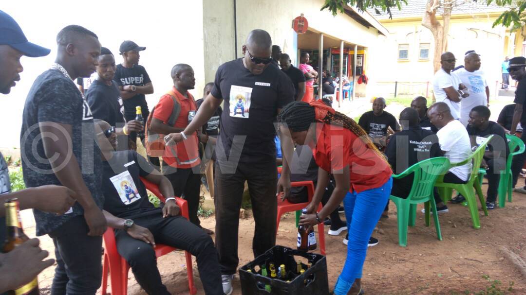 newvisionwire's tweet photo. Mourners parade posh cars and drink alcohol as they wait for the body of Ivan Semwanga at Entebbe Airport. Pictures by Martin Ndijjo. https://t.co/xMQ1vmSh7q