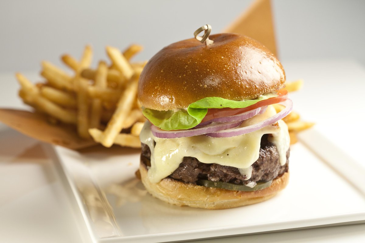 New to the menu at #SpiritBar, just in time for #nationalburgerday! Charlie Palmer Burger with aged cheddar, bacon, and all the fixins.