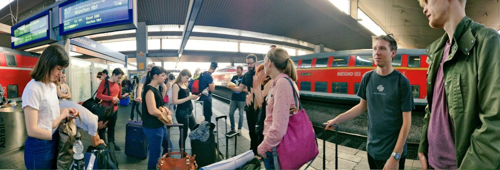 Photo of a bunch of IndieWeb community members standing around at a train station