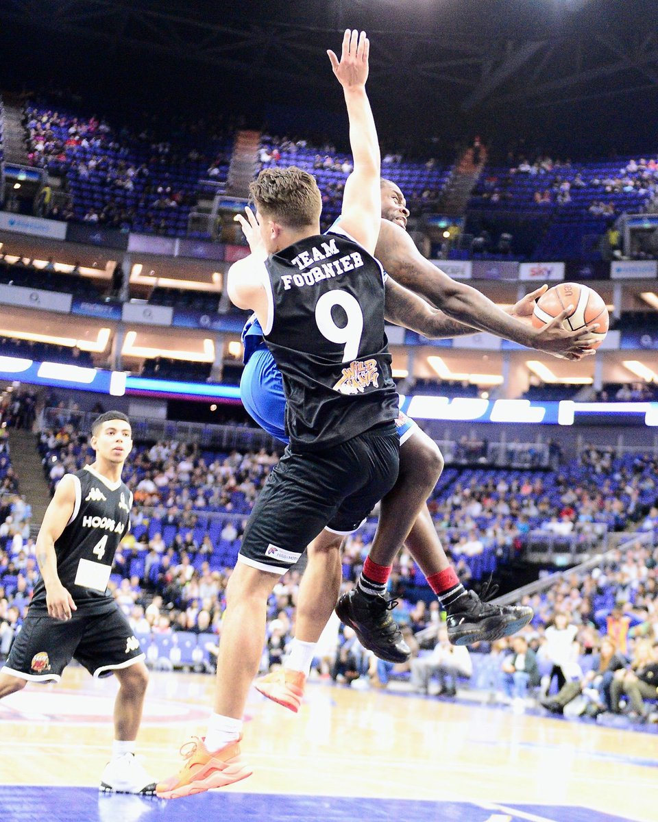 GrahamHodges3's tweet photo. @OfficialJET10 approaching the basket, but confronted by @JordanWeekender at @HoopsAid #foul #basketball #HoopsAid #theO2 https://t.co/vOwVWT8vm5