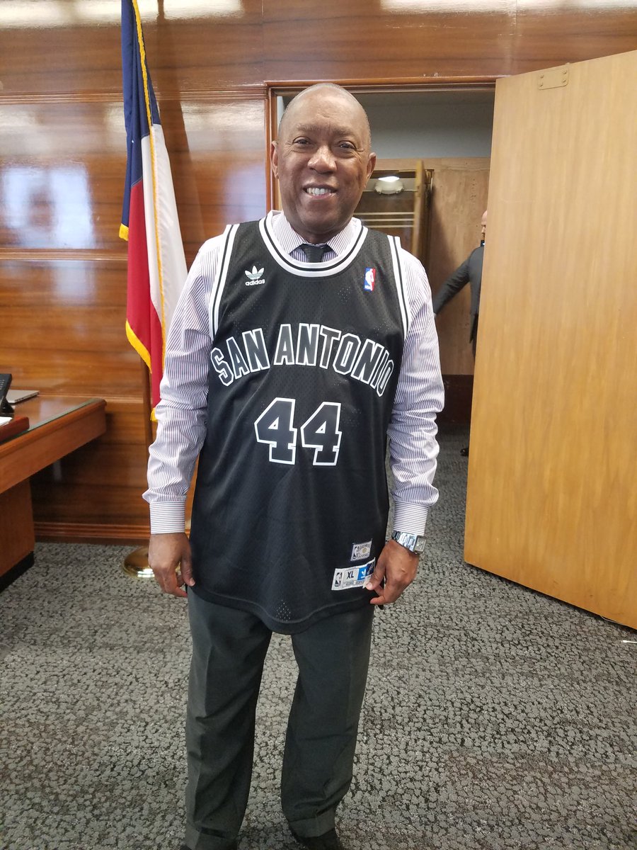 SylvesterTurner's tweet photo. In keeping good on my friendly wager w/ @IvyRTaylor, I wore my custom @spurs jersey to work today 😑😎. Next year @HoustonRockets next year... https://t.co/9trxgSmtL6