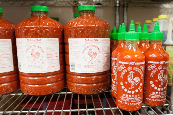 A Look Behind the Counter at Yang Kee Noodle. HOT STUFF!!! Sriracha by the gallon! Pour it on if you dare!