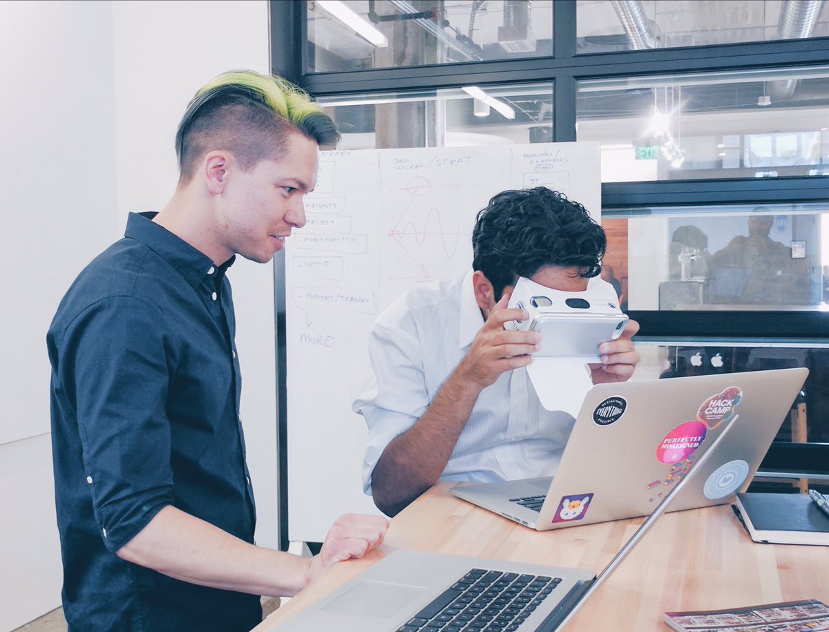 Two designers view mock ups using VR simulations of low vision to better understand users