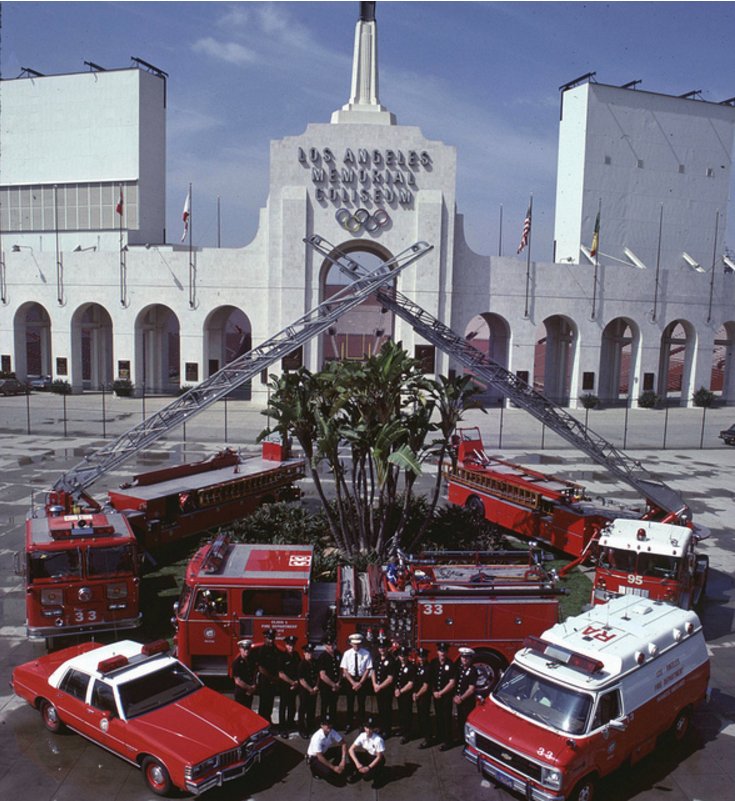 Emergengy vehicles from the Los Angeles Fire Department pose in front of the Los Angeles Memorial Coliseum in May 1984.