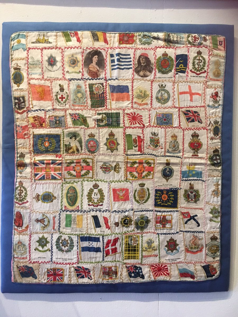 TamesideLibrary's tweet photo. This cushion cover is made up of flags, crests and other #WW1 Allies motifs. On show at Central Art Gallery https://t.co/vPhqejSZsk https://t.co/IzCa79dFeL
