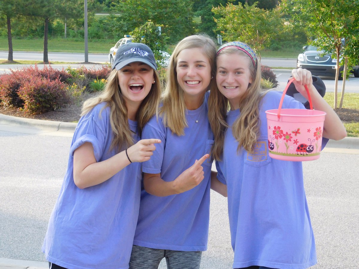 Student Council members accept donations from the car rider line for the Cap on Cancer fundraiser supporting Jack and Julia's Photo Shack.