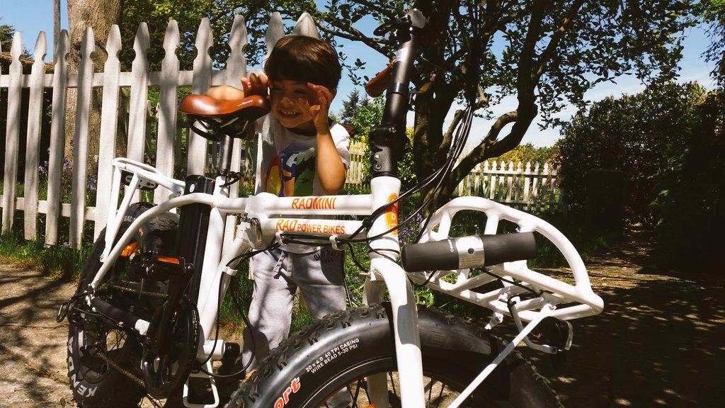 NateKZOK's tweet image. Its #BikeToWorkDay and here's my son doing the 12 point inspection before I ride my #Radpowerbike to work.