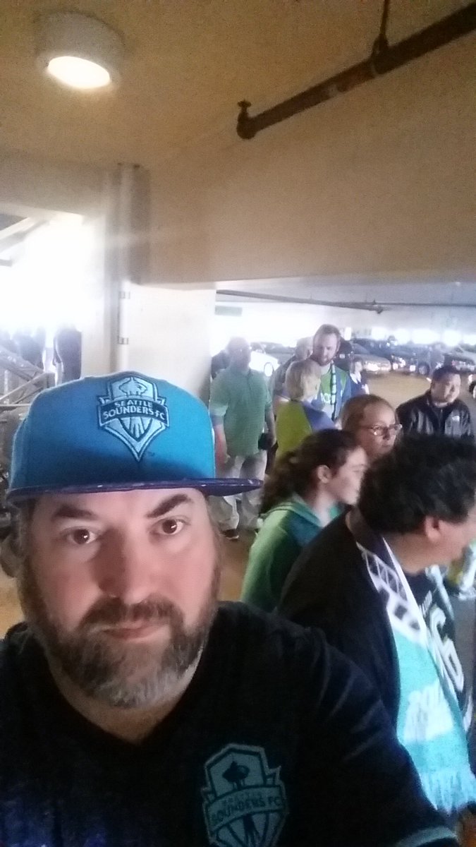 waiting to get in to the <a href="/SoundersFC/">Seattle Sounders FC</a> game but can't yet because the cop is late or something?