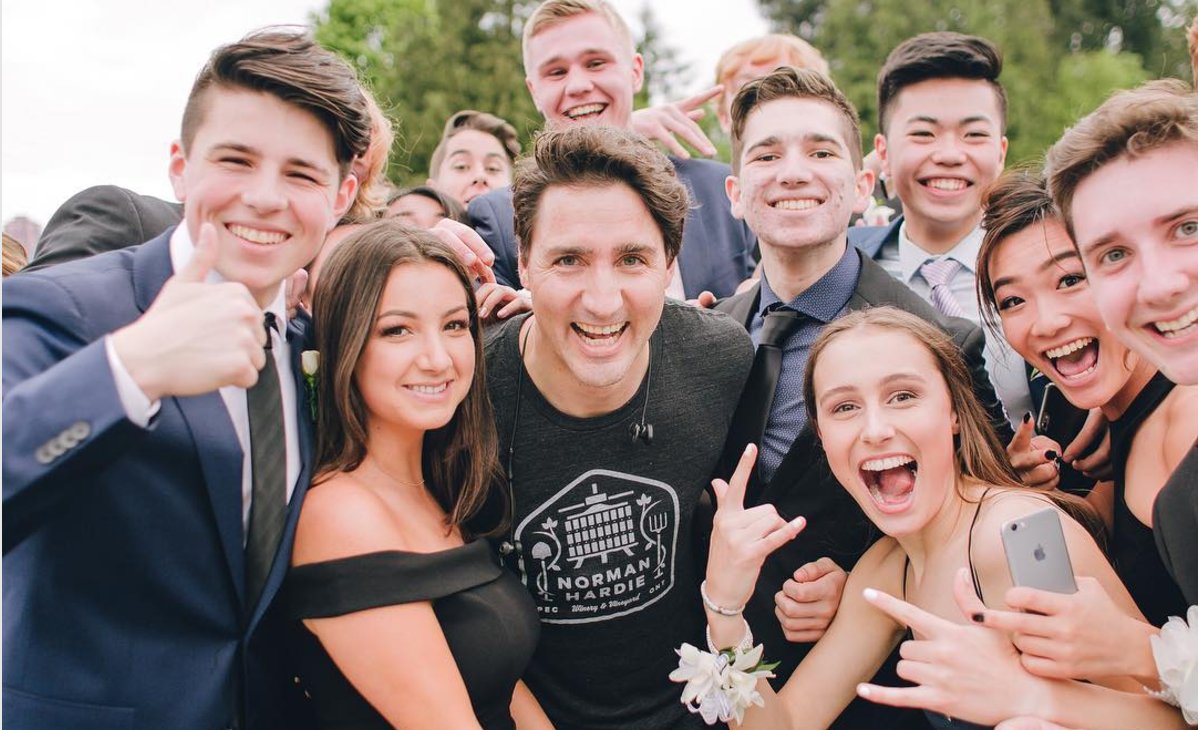 thehill's tweet photo. Justin Trudeau poses with prom-goers during afternoon run https://t.co/R6h6ZhuXSf https://t.co/NoZMWCm4ar
