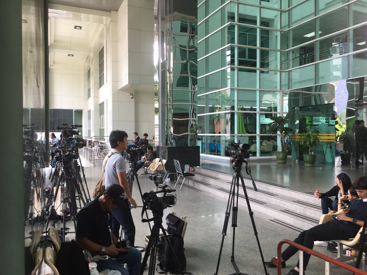 PanuCNA's tweet photo. Phra Mongkut Hospital is functioning as normal after this morning bomb. Main entrance to the building hit still blocked, media camp outside https://t.co/KhUCSvbOil