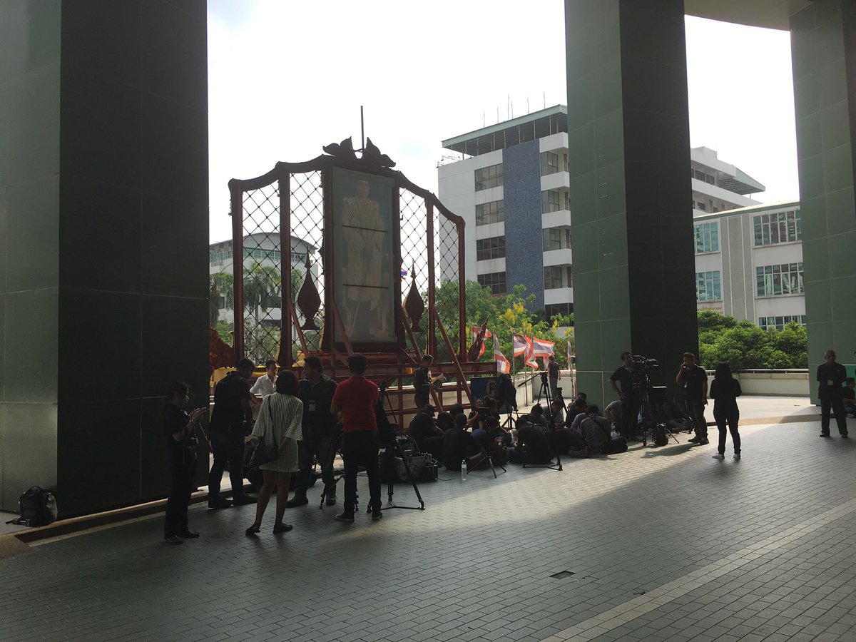 PanuCNA's tweet photo. Phra Mongkut Hospital is functioning as normal after this morning bomb. Main entrance to the building hit still blocked, media camp outside https://t.co/KhUCSvbOil