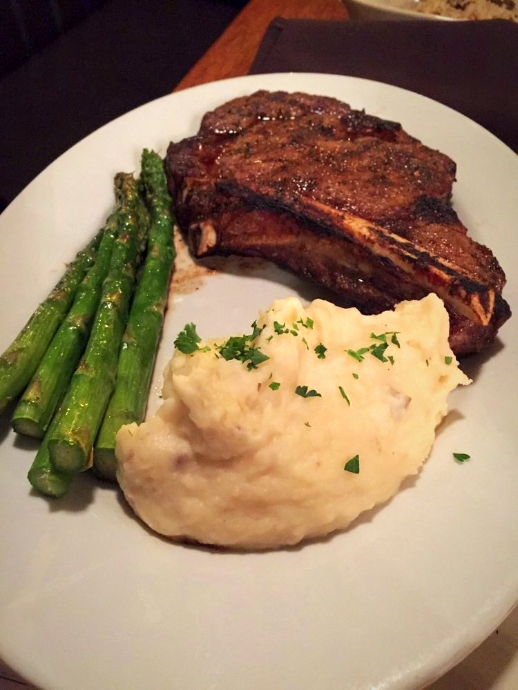 Tender bone-in rib-eye with crisp tender asparagus and mashed potatoes. Does it get any better? (photo: Dio P., Yelp) #discoverwinters