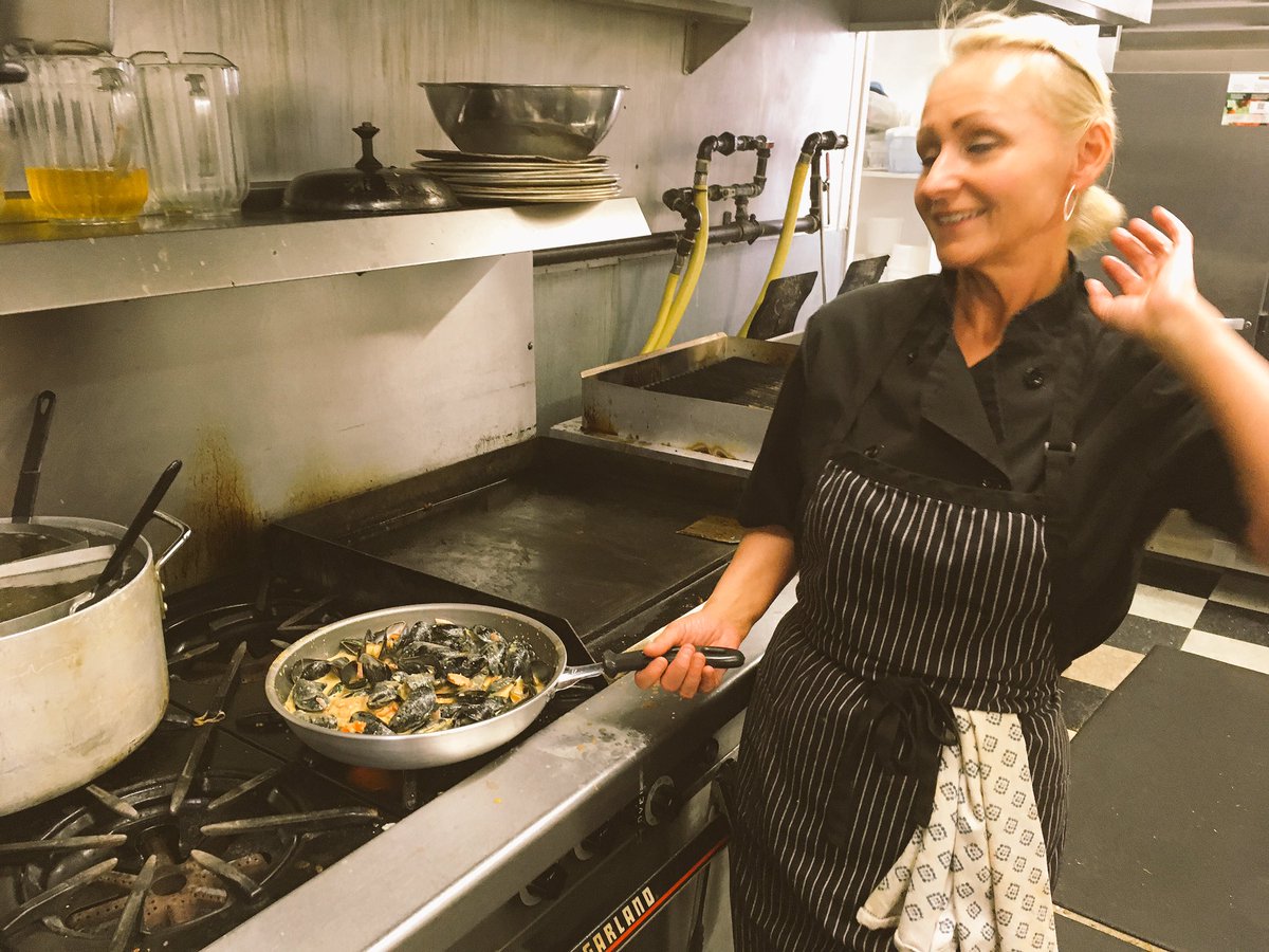 SouWestBarGrill's tweet photo. Chef Joanne prepares a new dish. #Portuguese mussels and Thai noodles with curry. #Newlondonbaymotel #villagepottery #thetablepei # https://t.co/JVLEcEnulH