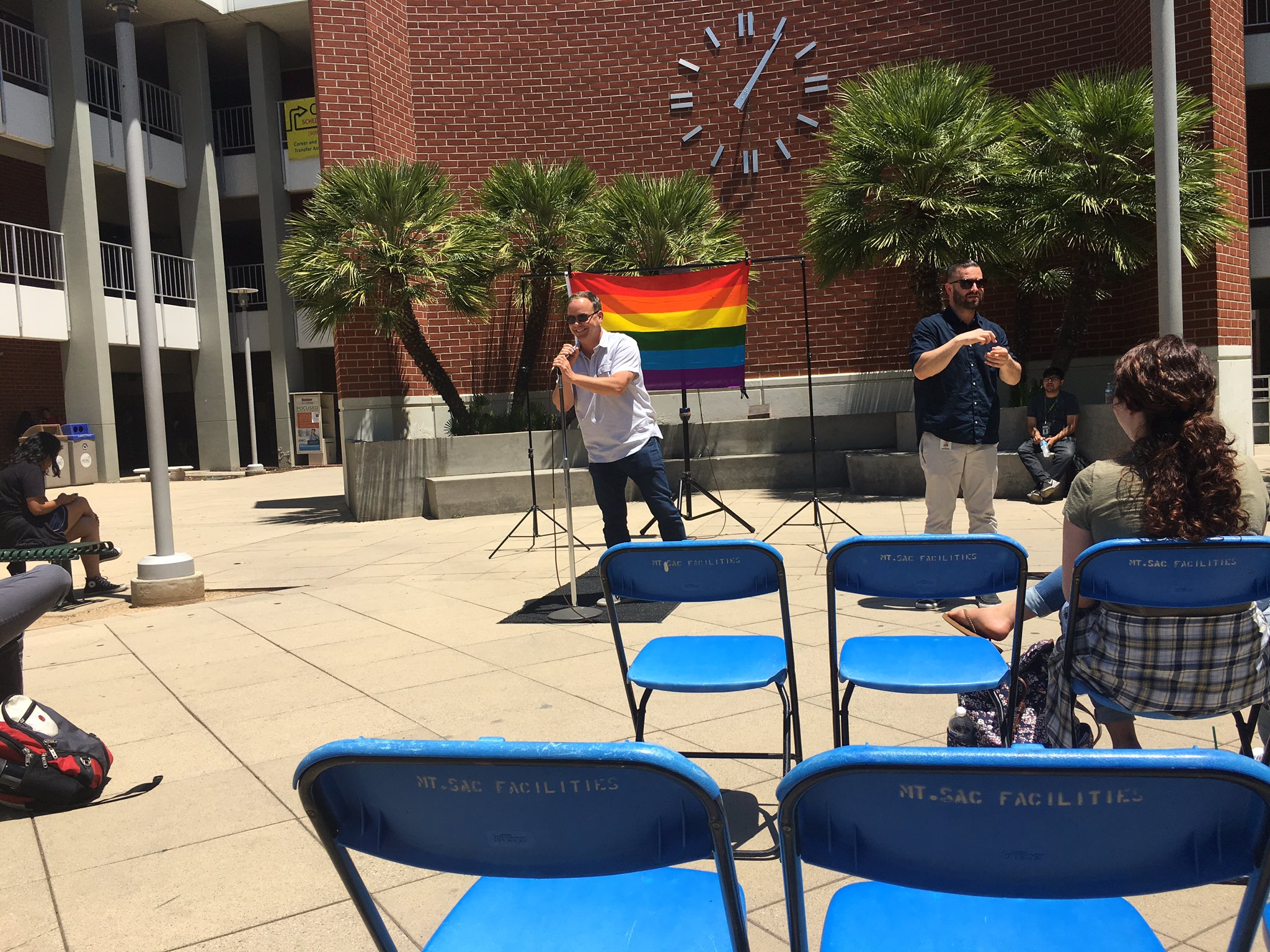 One of the professors leads the crowd in singing \"Happy Birthday\" to Harvey Milk. 