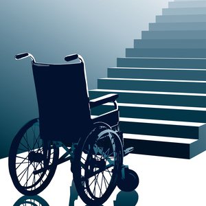 A wheelchair sat at the bottom of some stairs.