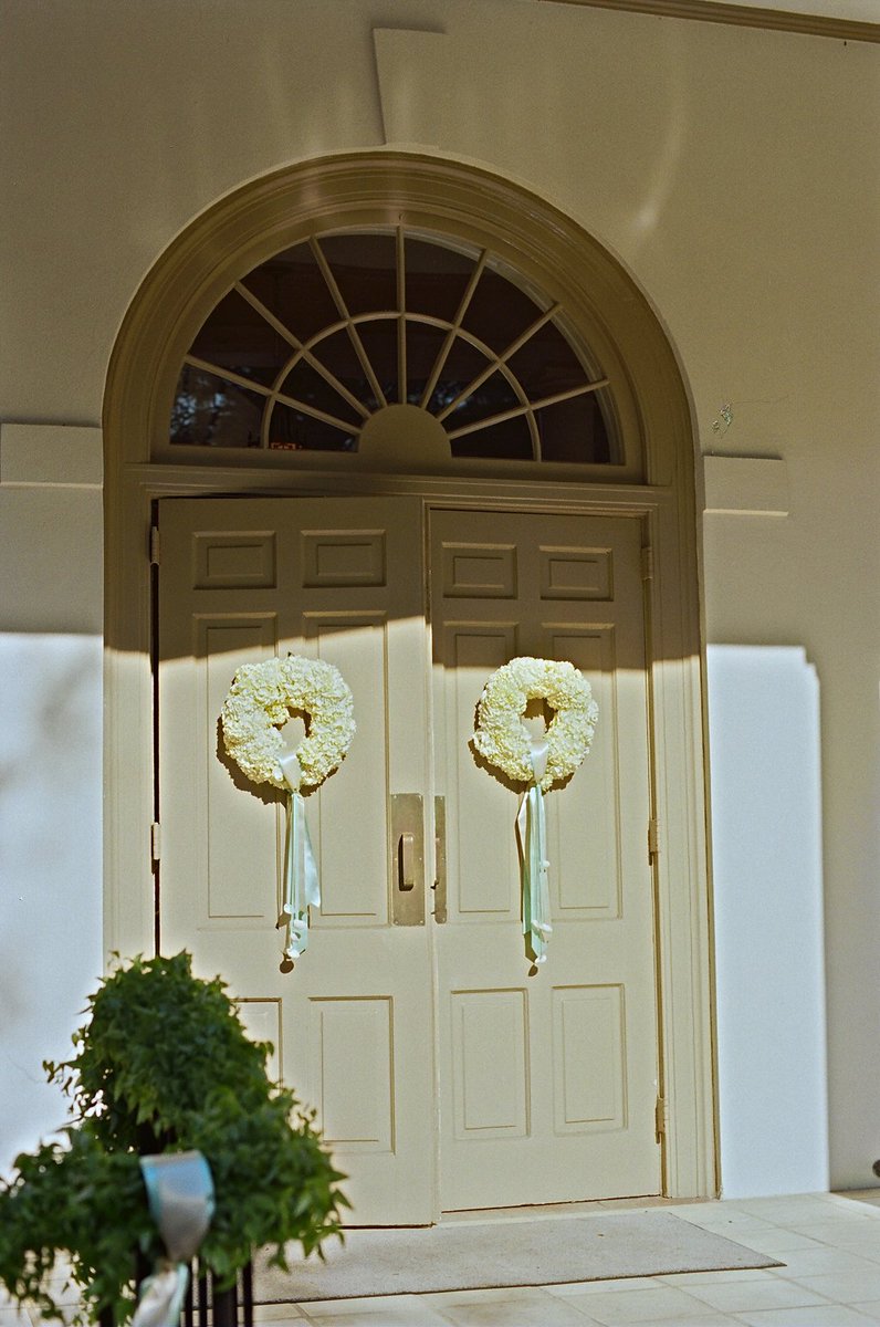 Fluffly white wreaths with ribbons and shells- perfect on the #church doors #flowerfriday @lizbanfield
