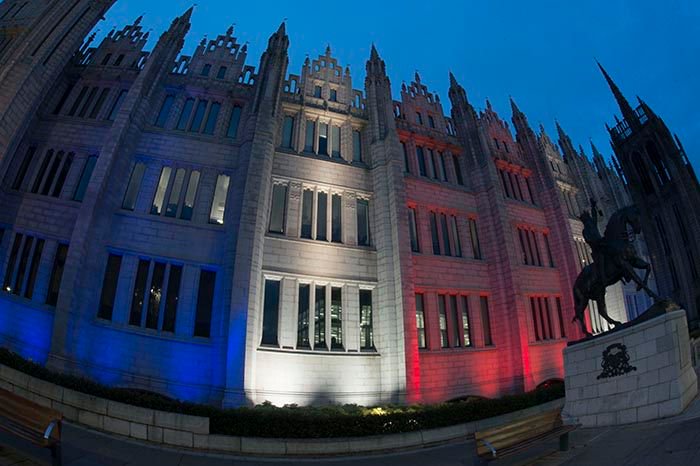 Marischal College glows red, white &amp; blue until 10.30pm each night from tonight onwards to show our solidarity with #Manchester