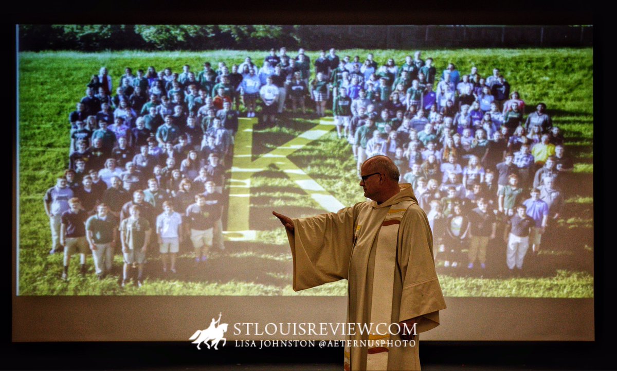 Father Richard Wosman <a href="/KennedyCatholic/">Kennedy Catholic HS</a> tearfully blesses keepsake medallions for students during final Mass of his closing school.