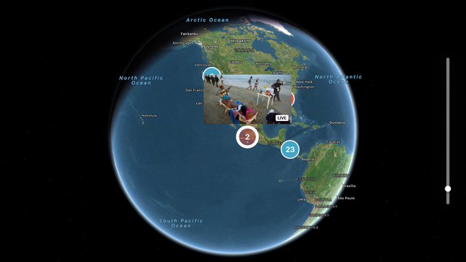 screenshot of new map functionality on Twitter Apple TV app update, showing the round blue earth as a map with zoom in points in middle of black image, vertical slider bar on far right
