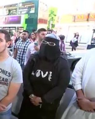 Elliotpond's tweet image. Channel 4 news today, notice the women in the background. Love with the o as a bomb on her clothing?