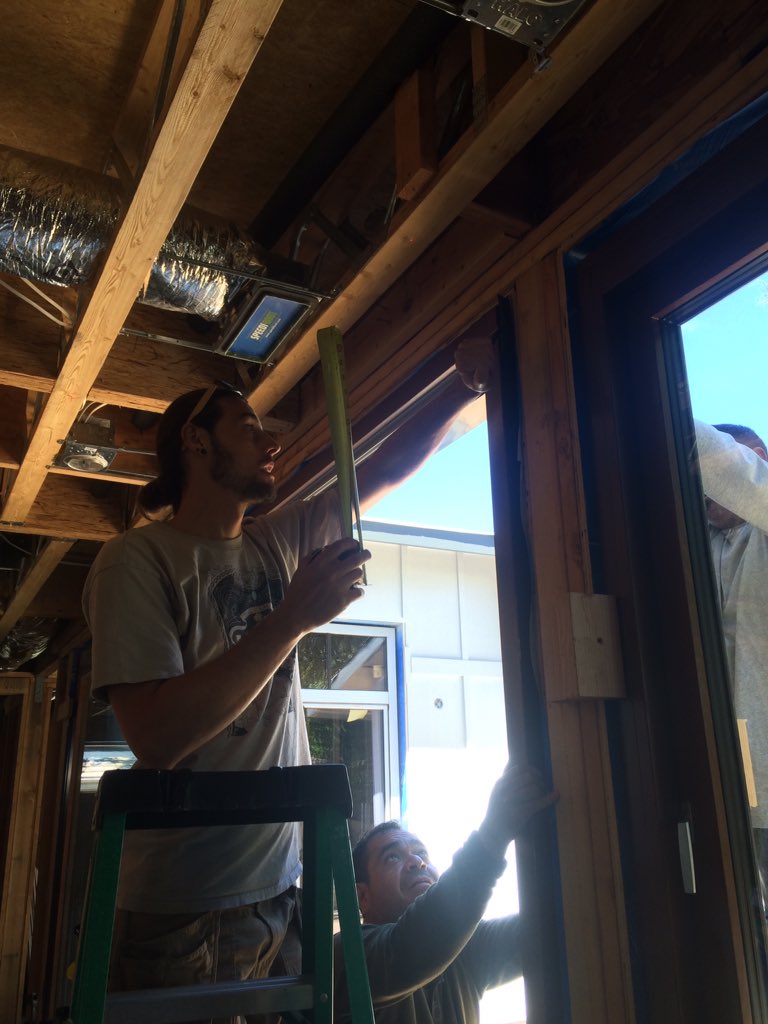 OneSkyHomes's tweet photo. @ZolaWindows Josh from @ZolaWindows shows our crew how to plumb and true the 16'x9' door. (Using nifty Winbag temp shims &amp; laser level.) https://t.co/BZlNMjItlK